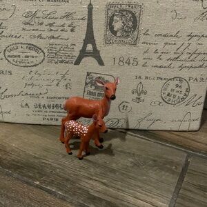 A doe deer and a fawn baby deer